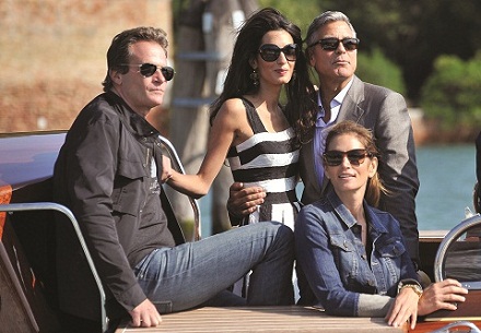 George Clooney, top right, his fiancee Amal Alamuddin, Cindy Crawford, bottom right and her husband Rande Gerber arrive in Venice, Italy, Friday, Sept. 26, 2014. George Clooney and his fiancee Amal Alamuddin arrived in Venice on Friday for their weekend wedding extravaganza, accompanied by loved ones and trailed by a clutch of photographers who recorded their passage along the picturesque Grand Canal. (AP Photo/Luigi Costantini)
